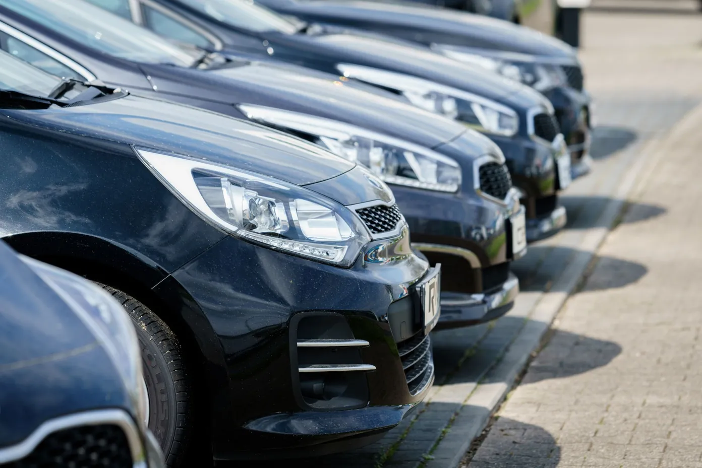 Row of fleet vehicles parked side by side