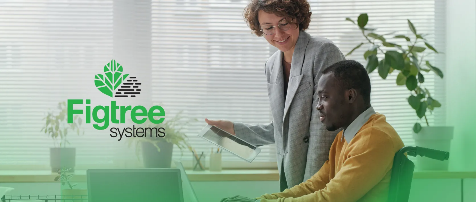 Figtree Systems claims management — two colleagues reviewing software on a laptop